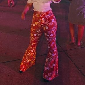 Orange bell bottom pants with floral pattern. Brand: Altar’d State. Size: medium